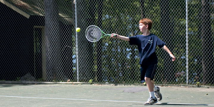 Playing tennis at Adirondack Camp for kids