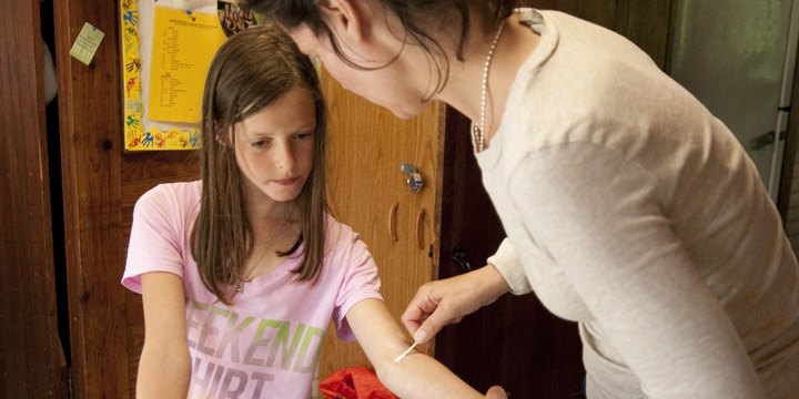 The camp doctor checks a camper