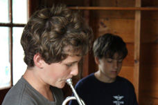 A Boy Playing a Trumpet at Traditional Overnight Camp
