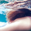 Girl under water swimming at camp